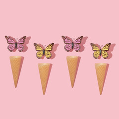 Spring creative pattern with colorful butterflies and ice cream cone on pastel pink background. 80s, 90s retro romantic aesthetic summer concept. Minimal surreal fashion idea.