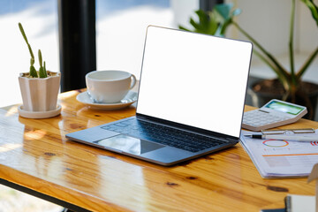A white screen computer on a wooden table can carry text messages or images on a blank screen.