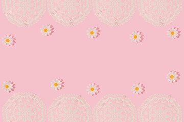 Spring creative frame with vintage embroidery lace placemat and white flower heads on pastel pink background. 80s, 90s retro romantic aesthetic summer concept. Minimal old times fashion idea.