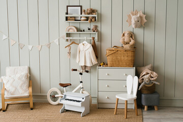 Scandinavian-style children's room: chest of drawers, bicycle, toys, piano toy