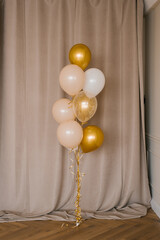 Festive balloons in gold, pink and white in a bouquet