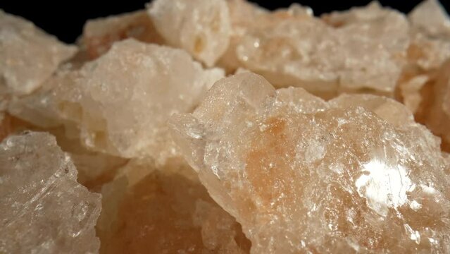 Pink Himalayan salt crystal. Macro. Dolly shot.