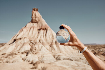 Woman holding sphere shaped water bottle in hand