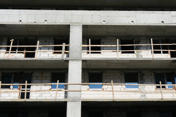 Luxurious apartments for sale. Bricks and concrete. Construction site background. High block of flats living area. New building neighborhood in progress. Real estate market in Europe.