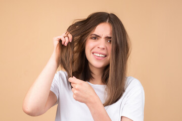 Hair for hair loss problem, woman show her hair tangled damaged hair.
