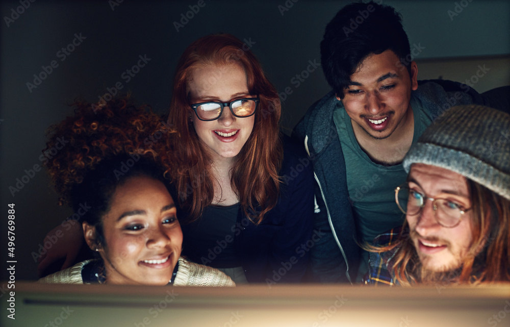 Aufkleber Coming together and giving their all. Shot of a business team looking at a computer screen on a night shift at the office.