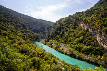 Fototapeta na wymiar Deep turquoise river at the bottom of a vertical canyon