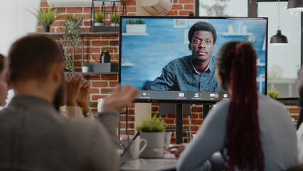 Close up of business people using online teleconference call in startup office. Colleagues talking on remote video call and conference to person, telecommunication in workspace.