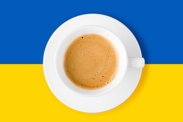 Black coffee in a cup on Ukraine flag blue and yellow background