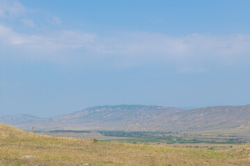 spacious green fields and mountains in georgia in summer
