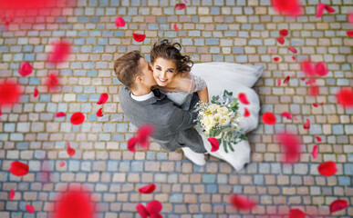 happy beautiful wedding couple kisses. wedding day. let it rain roses.