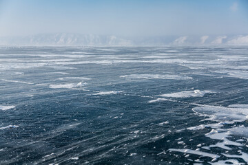 Naklejka na ściany i meble Frozen Baikal lake and wind. Clear ice and snow