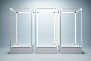 Empty illuminated glass showcase with mock up place on white wall backdrop. 3D Rendering.