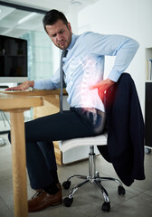 Work demands are taking a toll on his health. Shot of a young businessman experiencing back pain highlighted in glowing red at work.
