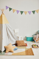 Minimal background image of cute kids room interior with play tent and decor in pastel colors