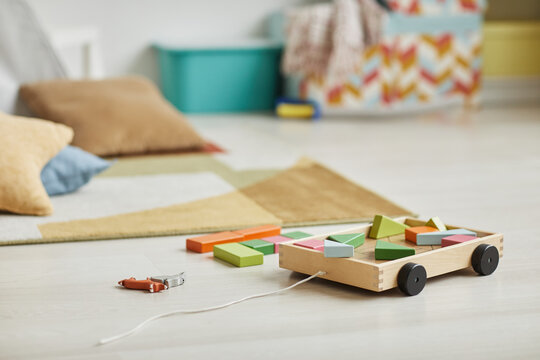 Close up background image of wooden toy set in minimal kids playroom interior, copy space