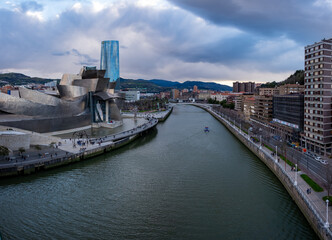 Panoramic view of the Nervión river and the Guggenheim museum on a cloudy day, of the city in...