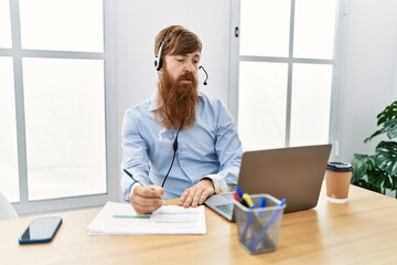 Young irish call center agent concentrate working at the office.