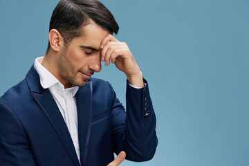 business man with a thoughtful expression keeps his hand on his head work process manager blue background copyspace