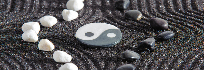 Japanese zen garden with yin and yang and feng shui in textured sand