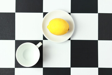 Tea with lemon on a chessboard.