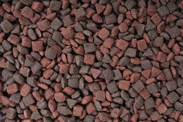Multi colored dryed food for cats and dogs. Horizontal background texture.