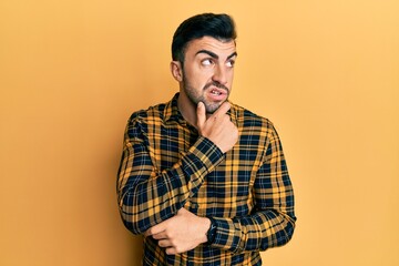 Young hispanic man wearing casual clothes thinking worried about a question, concerned and nervous...