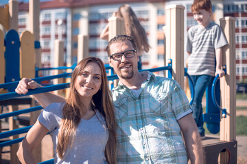 portrait of happy parents on the Playground.