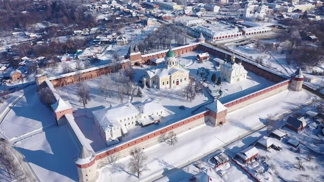 View from drone of snow covered architectural ensemble of Zaraysk Kremlin with Forerunner and St. Nicholas cathedrals on winter day, Russia