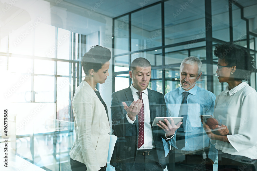 Leinwandbilder i just need some advice to help me to decide.... shot of a business team using a digital tablet whil