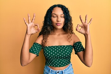 Young latin woman wearing casual clothes relax and smiling with eyes closed doing meditation gesture with fingers. yoga concept.