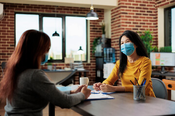 Asian businesswoman interviewing freelancer person discussing business collaboration during interview meeting in startup office. Businesswomen analyzing graphs working at management startegy