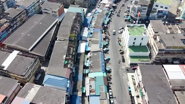 MAEKLONG, THAILAND - DECEMBER 15, 2019: Amazing aerial view of Maeklong cityscape with river and railway market