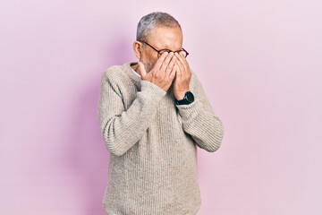 Handsome senior man with beard wearing casual sweater and glasses rubbing eyes for fatigue and...
