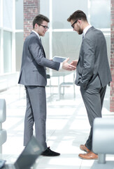 Fototapeta premium handshake two employees standing in the office