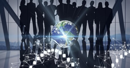 Spot of light and network of connections over globe against silhouettes of businesspeople