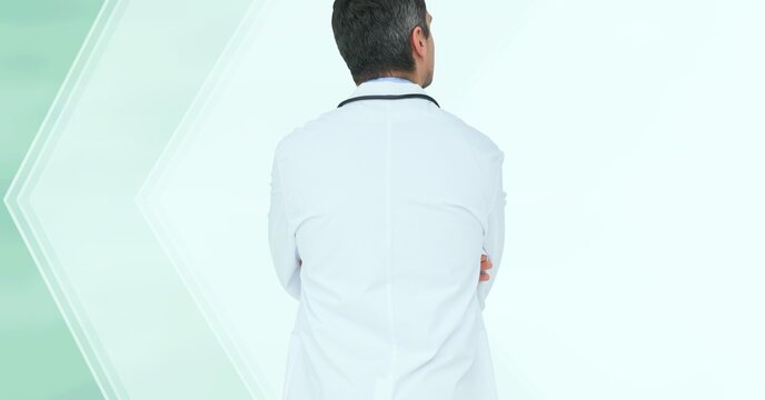 Composition of rear view of male doctor in lab coat and stethoscope with copy space