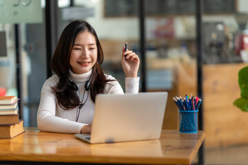 Education study abroad, Asian student girl look at laptop while doing homework making video call abroad using internet friend connection, businesswomen use computer analysis finance data