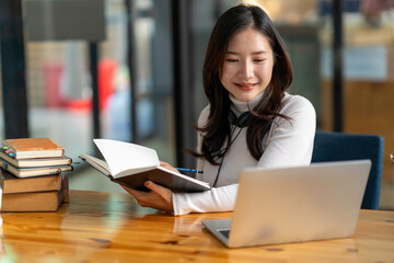 Education study abroad, Asian student girl look at laptop while doing homework making video call abroad using internet friend connection, businesswomen use computer analysis finance data