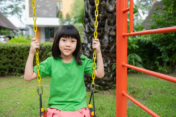 chinese children playing swing, kids have fun with playground