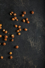 Fototapeta na wymiar Hazelnut on dark moody black with grey concrete texture or background. With place for text and image