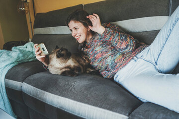 Young woman at home resting with her pet