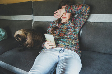 Young and worried woman teleworking alone at home