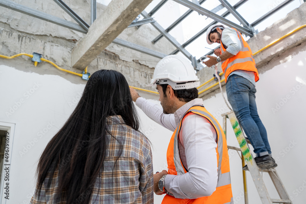 Poster engineer technician watching team of workers on high steel platform at construction site,engineer wo