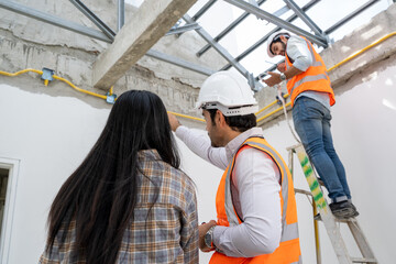 Engineer technician watching team of workers on high steel platform at construction site,Engineer working on construction building site. © visoot