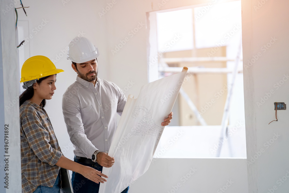 Poster engineer and architect discussing building plan at construction site,group of builders having conver