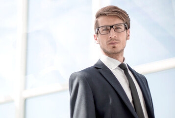 confident businessman on background of office window