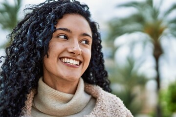 Young hispanic woman smiling confident at park