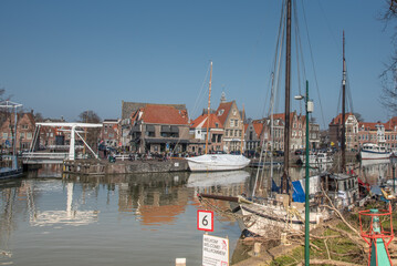 Hoorn, Netherlands, March 2022. The harbor of Hoorn with the old boats and historic facades.