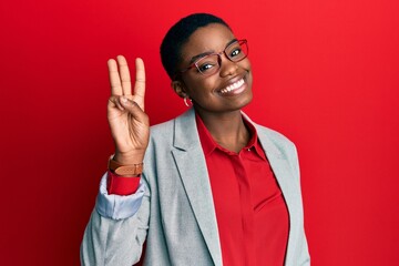 Young african american woman wearing business jacket and glasses showing and pointing up with fingers number three while smiling confident and happy.